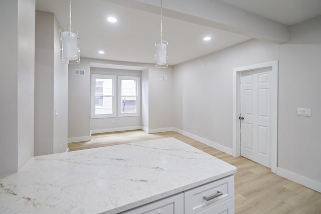 spare room featuring light wood finished floors, recessed lighting, and baseboards