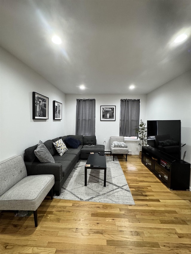 living room featuring light wood-style flooring and recessed lighting