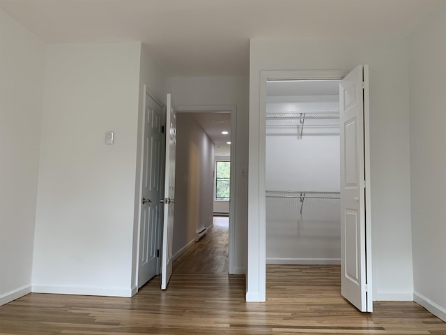 interior space featuring baseboards and wood finished floors