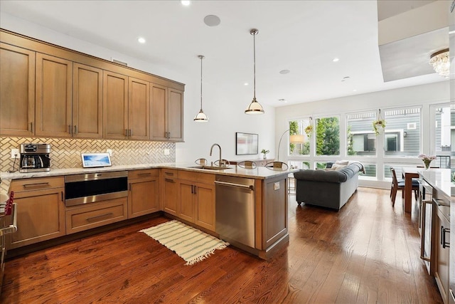 324 Hudson St # 1, Hoboken, NJ 07030 - kitchen featuring dishwasher, a sink, a peninsula, dark wood-style floors, and backsplash