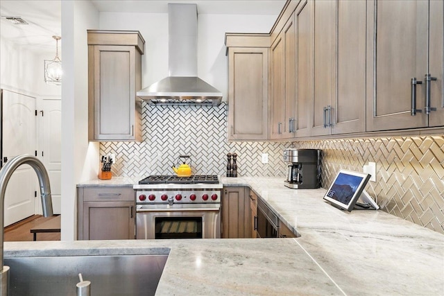 324 Hudson St # 1, Hoboken, NJ 07030 - kitchen with wall chimney range hood, high end range, a sink, decorative backsplash, and light stone counters