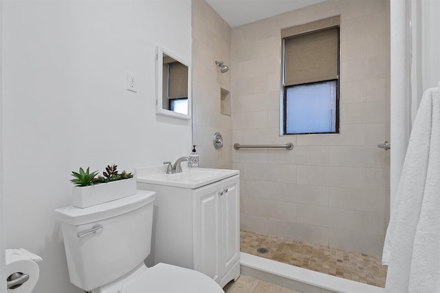 bathroom featuring tile patterned floors, curtained shower, vanity, and toilet