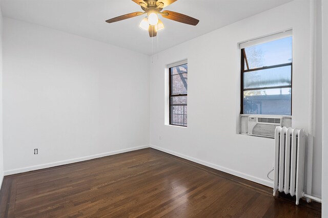 179 Manhattan Ave Unit 3B, Jersey City, NJ 07307 - spare room featuring radiator heating unit, dark wood-style floors, and baseboards