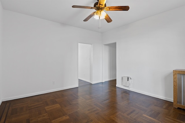 unfurnished room featuring dark parquet floors and ceiling fan