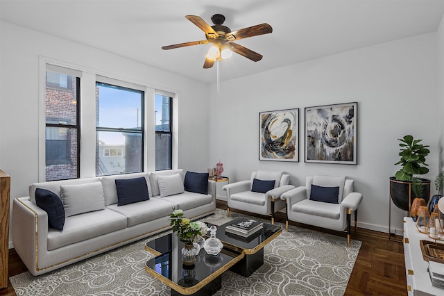 living room featuring ceiling fan and dark parquet floors