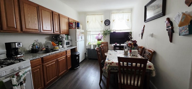 6801 Durham Ave, North Bergen, NJ 07047 - kitchen featuring white appliances, radiator, dark wood-type flooring, and brown cabinets