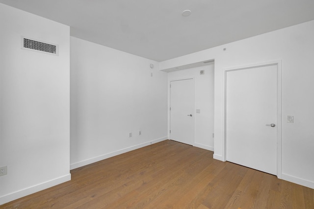 unfurnished bedroom with wood-type flooring