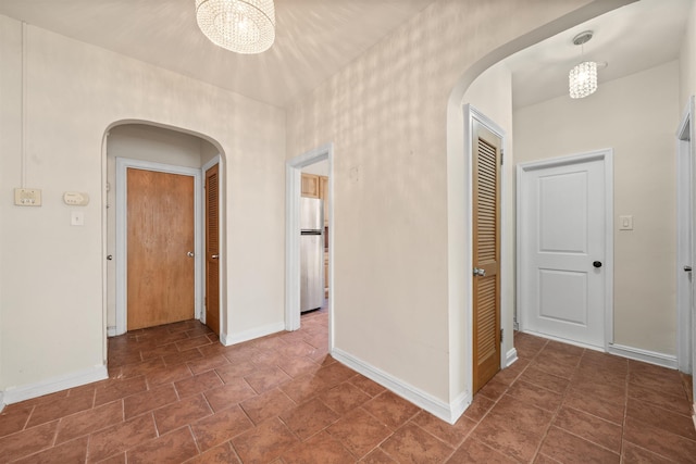 101 Kensington Ave Unit A1, Jersey City, NJ 07304 - hallway with arched walkways, a chandelier, and stone finish floors