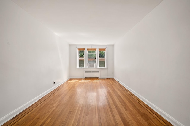 101 Kensington Ave Unit A1, Jersey City, NJ 07304 - spare room with radiator heating unit, light wood-style flooring, and cooling unit