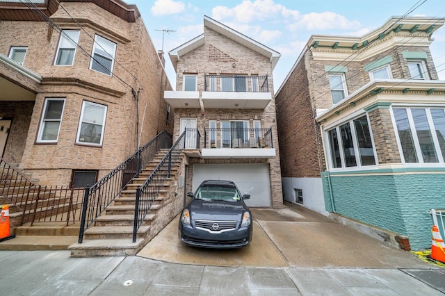 308 18th St, Union City, NJ 07087 - townhome / multi-family property featuring stairs, an attached garage, and concrete driveway