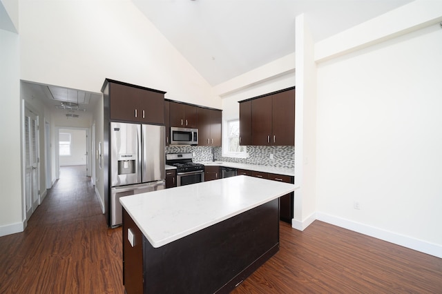 308 18th St, Union City, NJ 07087 - kitchen with dark wood-style flooring, tasteful backsplash, dark brown cabinets, light countertops, and stainless steel appliances