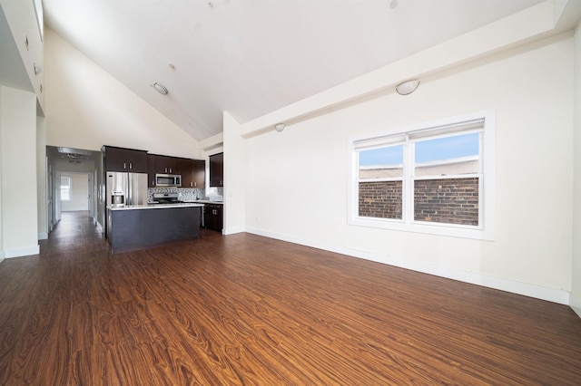 308 18th St, Union City, NJ 07087 - unfurnished living room with high vaulted ceiling, baseboards, and dark wood-type flooring