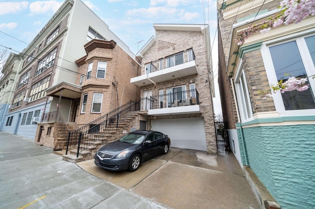 308 18th St, Union City, NJ 07087 - view of property with stairway, an attached garage, and driveway