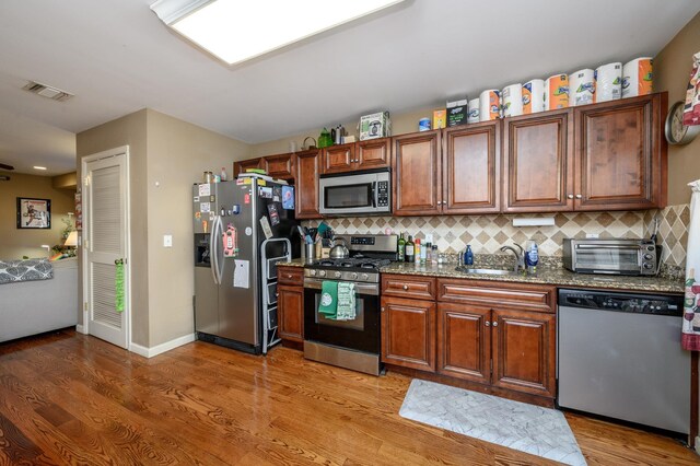 135 38th St Unit 407, Union City, NJ 07087 - kitchen with visible vents, a toaster, tasteful backsplash, appliances with stainless steel finishes, and a sink