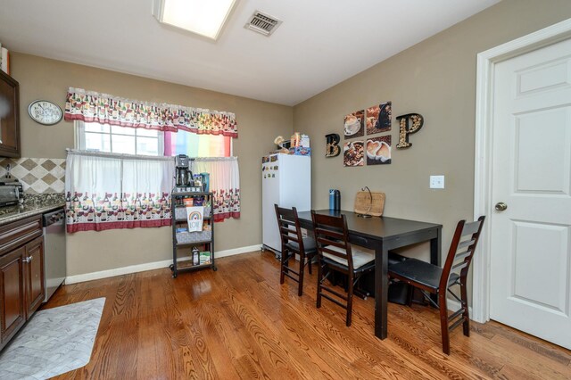 135 38th St Unit 407, Union City, NJ 07087 - dining space with baseboards, visible vents, and wood finished floors