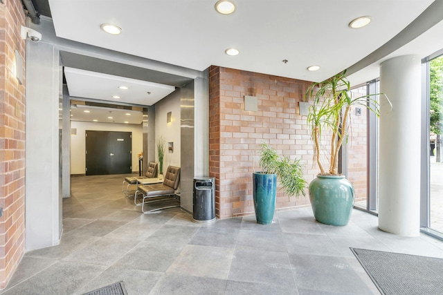 601 Observer Hwy Unit 204, Hoboken, NJ 07030 - common area with recessed lighting and brick wall