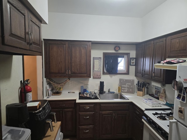 4524 Smith Ave, North Bergen, NJ 07047 - kitchen featuring white range with gas cooktop, dark brown cabinetry, light countertops, and ventilation hood