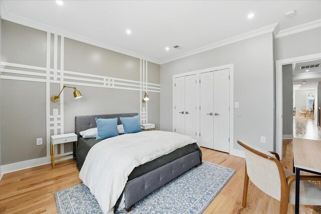 181 Bartholdi Ave Unit 2, Jersey City, NJ 07305 - bedroom with ornamental molding, light wood-type flooring, two closets, recessed lighting, and baseboards
