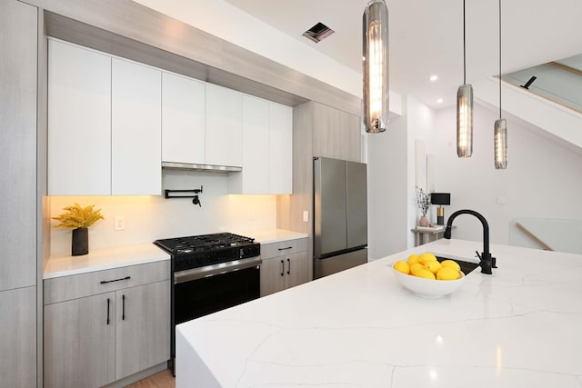 262 Webster Ave Unit 2, Jersey City, NJ 07307 - kitchen featuring stainless steel appliances, modern cabinets, light stone counters, hanging light fixtures, and recessed lighting