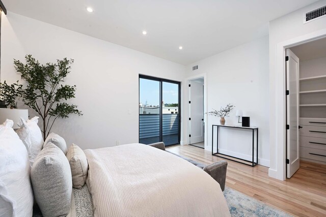 262 Webster Ave Unit 2, Jersey City, NJ 07307 - bedroom featuring light wood-style flooring, access to outside, a walk in closet, and recessed lighting