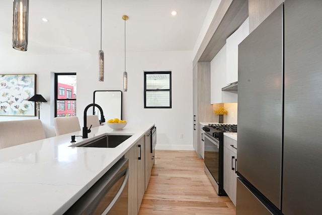 262 Webster Ave Unit 2, Jersey City, NJ 07307 - kitchen with appliances with stainless steel finishes, light wood finished floors, hanging light fixtures, modern cabinets, and recessed lighting