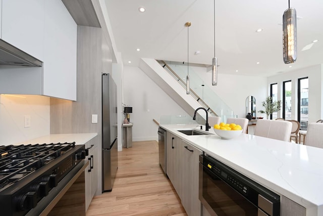 262 Webster Ave Unit 2, Jersey City, NJ 07307 - kitchen featuring modern cabinets, stainless steel appliances, light wood-style flooring, recessed lighting, and decorative light fixtures