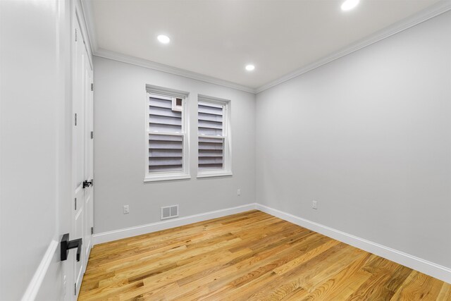 spare room featuring light hardwood / wood-style floors and ornamental molding