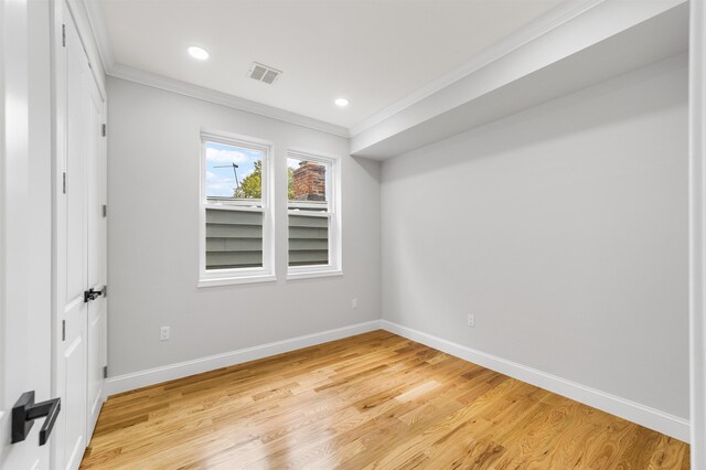 unfurnished room with ornamental molding and light hardwood / wood-style flooring