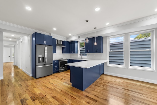 kitchen featuring a kitchen breakfast bar, wall chimney exhaust hood, blue cabinetry, appliances with stainless steel finishes, and kitchen peninsula