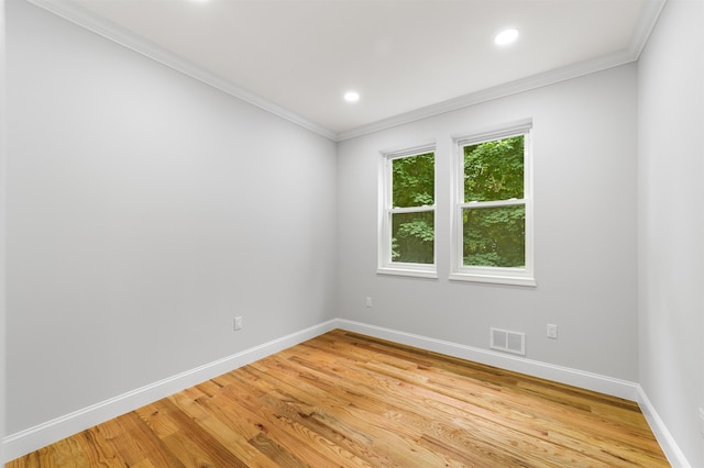 unfurnished room featuring wood-type flooring and crown molding