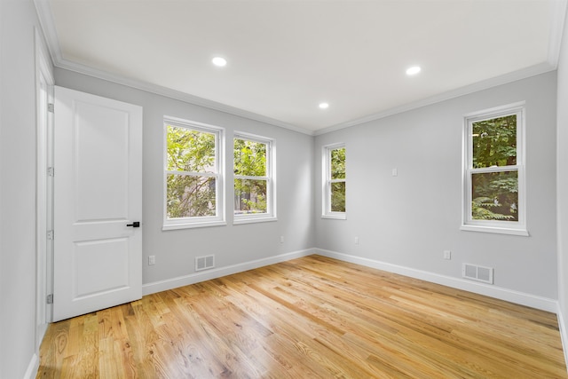 unfurnished room with ornamental molding and light hardwood / wood-style flooring