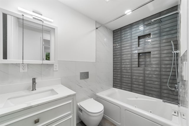 full bathroom with tiled shower / bath, vanity, toilet, and tile walls