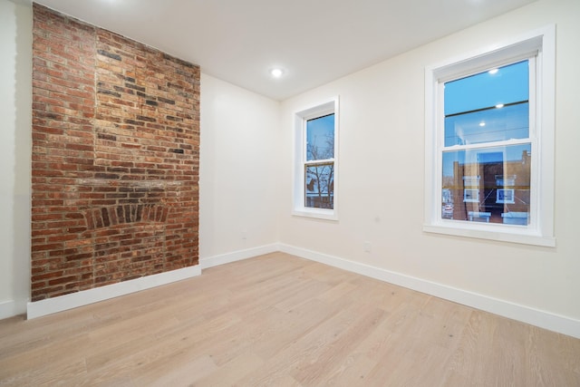 spare room with light hardwood / wood-style flooring