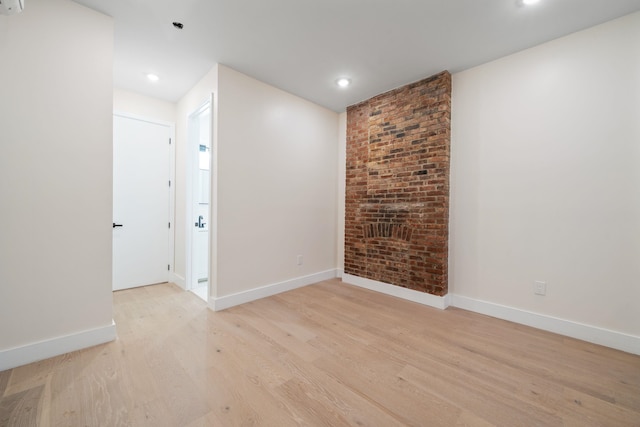 spare room with light hardwood / wood-style flooring