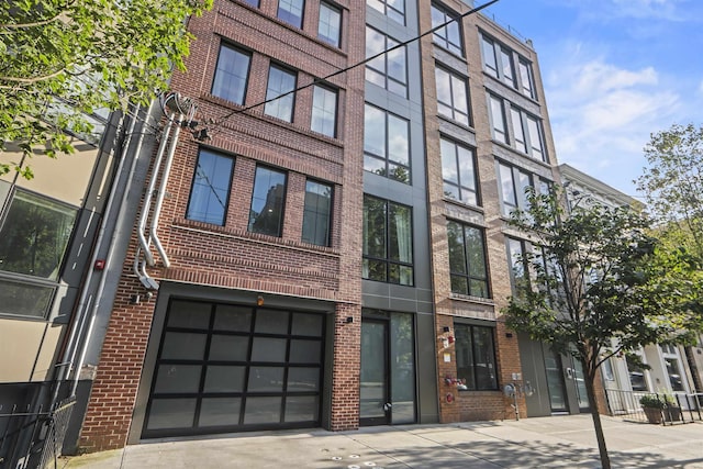 371 2nd St Unit 2B, Jersey City, NJ 07302 - view of building exterior featuring a garage and concrete driveway
