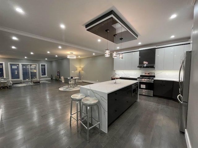 29 Carlton Ave Unit 2, Jersey City, NJ 07307 - kitchen featuring appliances with stainless steel finishes, extractor fan, a kitchen island, modern cabinets, and dark wood-type flooring