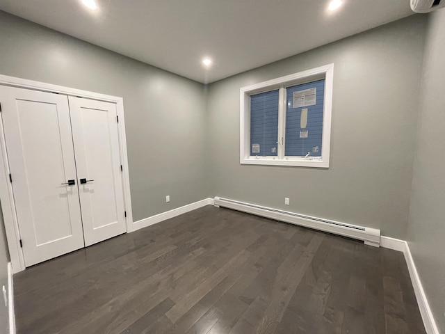 29 Carlton Ave Unit 2, Jersey City, NJ 07307 - empty room with a baseboard heating unit, recessed lighting, and dark wood-type flooring
