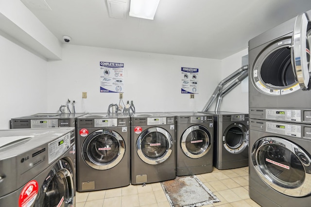 laundry room featuring stacked washer and dryer, light tile patterned flooring, and washer and dryer