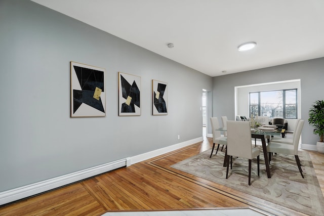 dining room featuring baseboard heating and light hardwood / wood-style flooring