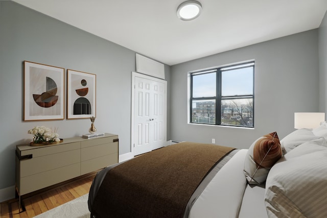 bedroom featuring light hardwood / wood-style floors and a closet