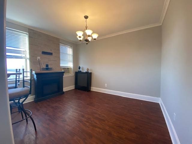 interior space featuring ornamental molding, dark hardwood / wood-style flooring, and a chandelier