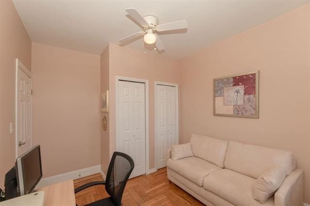 home office featuring ceiling fan and light parquet flooring