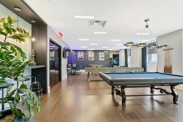 recreation room featuring visible vents, baseboards, wood finished floors, and pool table