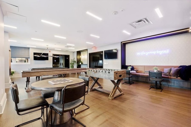 rec room featuring light wood-style floors and visible vents