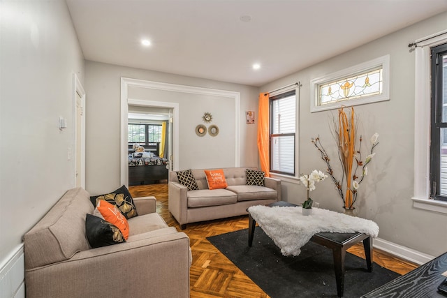 living room with parquet flooring and a healthy amount of sunlight