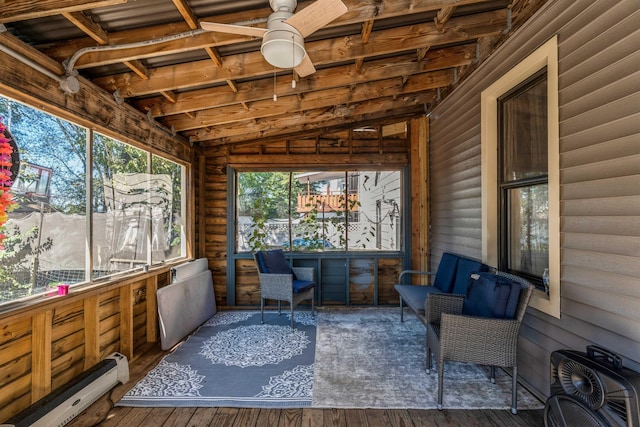 sunroom with lofted ceiling, a baseboard heating unit, and ceiling fan