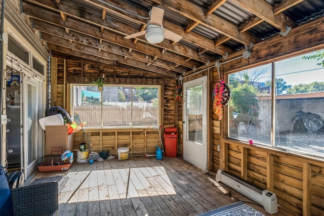 sunroom featuring a baseboard radiator and ceiling fan