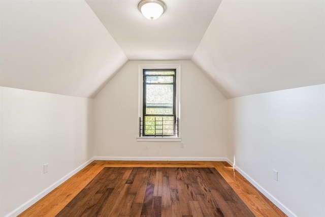 additional living space with lofted ceiling and hardwood / wood-style floors