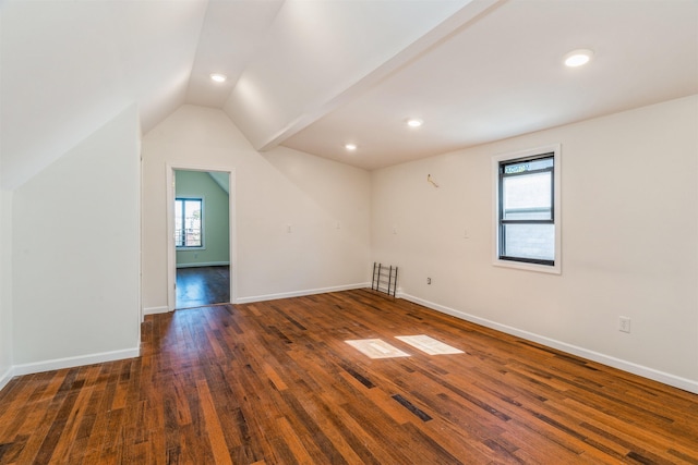 bonus room with vaulted ceiling and dark hardwood / wood-style floors