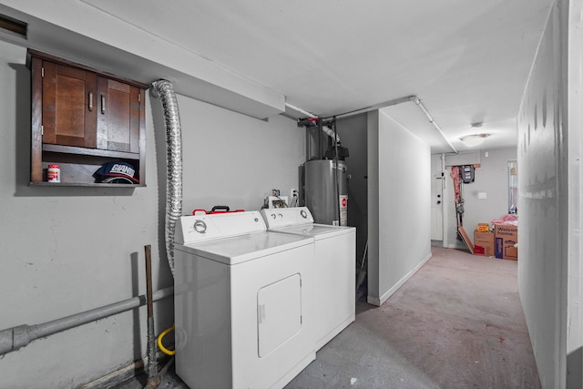 clothes washing area featuring water heater, laundry area, and washer and dryer